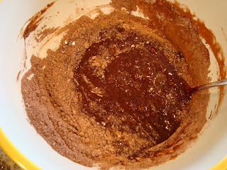 Spoon stirring milk and flour mixture together in bowl