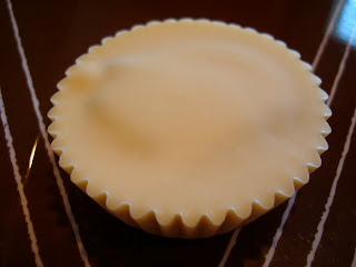 Close up of one unwrapped Vegan White Chocolate Chocolate-Peanut Butter Cup