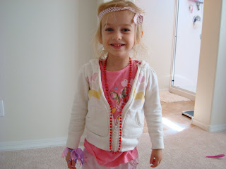 Young girl standing up showing her being dressed up