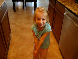 Young girl grasping hands in kitchen