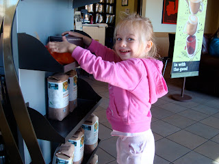 Young girl touching coffee display at Starbucks