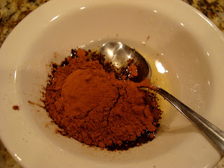 Cocoa powder and vanilla added to bowl