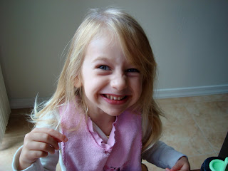 Young girl sitting at table smiling