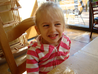 Young girl making silly face at table