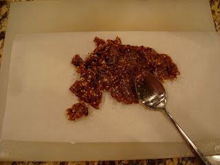 Raw Vegan Caramel dough being spread onto parchment paper
