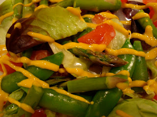 Salad drizzled with yellow mustard