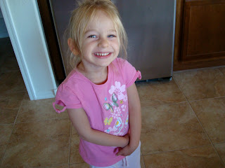 Little girl standing in kitchen smiling