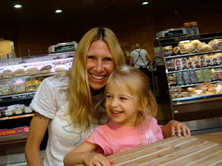 Woman and young girl smiling at table