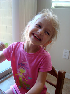 Young girl smiling sitting at children's table