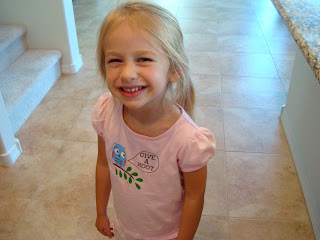 Young girl in pink shirt smiling