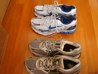 Two pairs of running shoes next to one another one old one new - 27