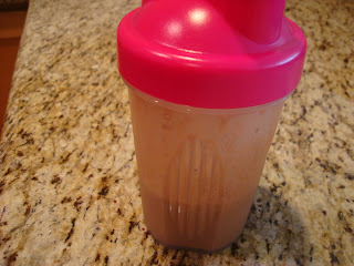 Chocolate protein powder and water mixed in blender bottle