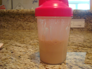 Protein powder mixed with water in shaker bottle after being mixed