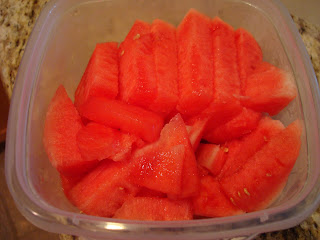 Sliced up watermelon in clear container
