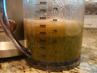 Measuring portion of juicer showing the juice that has been made