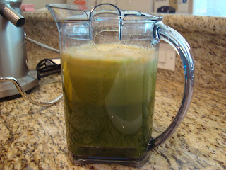 Container full of green juice from juicer