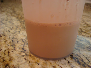 Brown Rice Protein Powder in bottom of shaker cup mixed with water