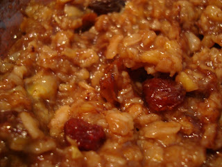 Up close of oatmeal in bowl showing off raisins