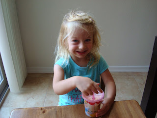Young girl smiling holding sippy cup full of smoothie mixture - 9