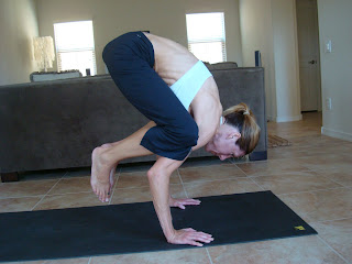 Woman doing the crane yoga pose