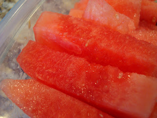 Sliced up watermelon in clear container