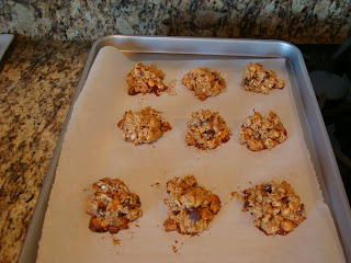 Maple Nut Chocolate Oat Clusters on baking sheet after coming out of oven