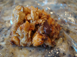 One Maple Nut Chocolate Oat Cluster on plastic wrap
