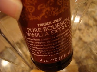 Hand holding bottle of Trader Joe's Pure Bourbon Vanilla Extract