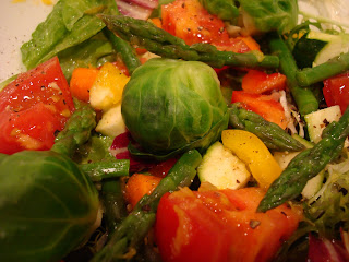 Bowl of greens and various vegetables with dressing in bowl