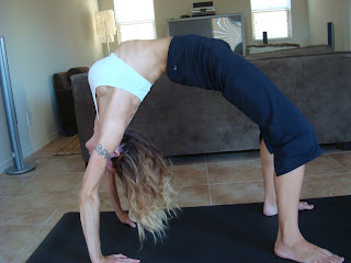 Woman doing Urdhva Dhanurasana yoga pose - 123