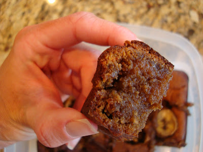 Hand holding a portion of a slice of Peanut Butter Banana Bread