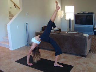 Woman doing Eka Pada Urdhva Dhanurasana yoga pose