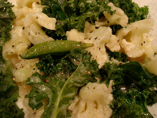 Kale Salad with mixed vegetables in dressing on white plate