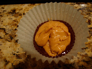 Peanut butter mixture spooned on top of chocolate in paper muffin liner