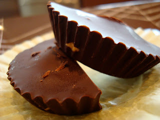 One split Vegan Peanut Butter Cup topped with another unwrapped one - 63
