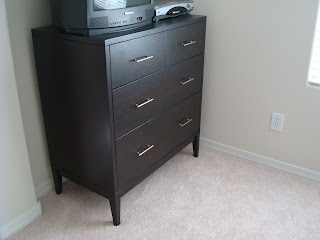 Dark colored dresser in room