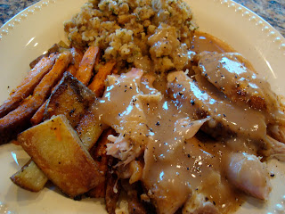 Plated thanksgiving meal covered with gravy