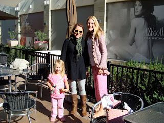 Two women and young girl standing outside at coffee shop