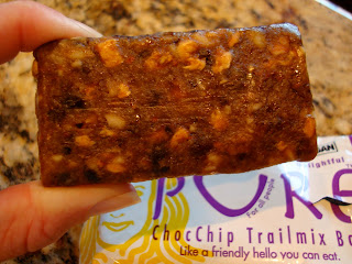 Hand holding Chocolate Chip Trail Mix Bar up close