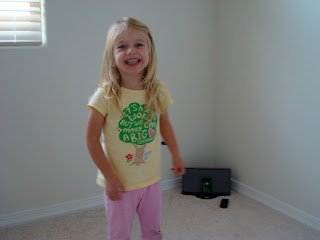 Young girl standing in room smiling