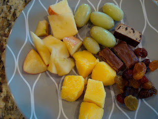 Various fruit and chopped up Cookie Dough Balance Bar on plate