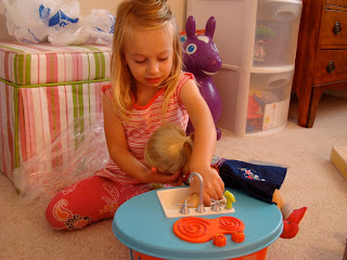 Young girl playing with new presents on floor