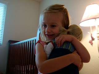 Young girl hugging a doll
