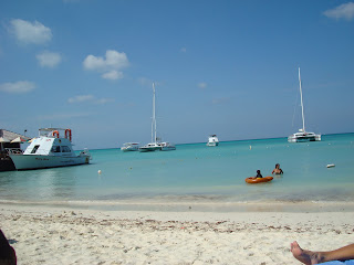 Beach in Aruba with boats and people in water - 51