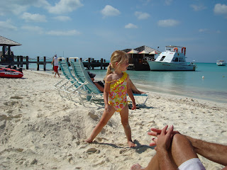 Young girl standing in bathing suit on beach in front of lounge chairs - 31