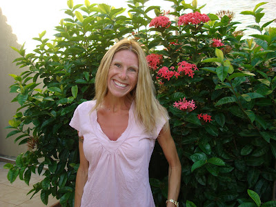 Woman standing in front of flower shrub