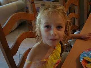Young girl sitting at table eating lunch