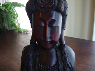 Close up of dark chocolate-colored wooden statue