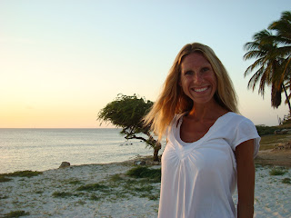 Close up of woman smiling on beach at sunset