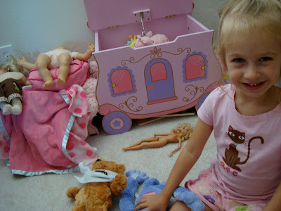 Young girl sitting in room playing with toys